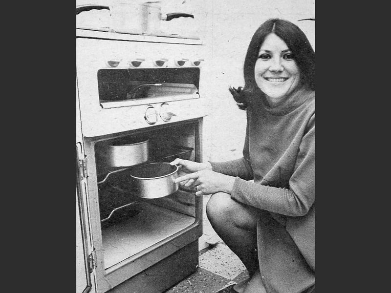 Mrs Diane Claydon of Elm Drive, Market Drayton, was one of the first in the area to have her cooker switched to natural gas. The original caption highlighted the arrival of natural gas supplies in the region, marking an early step in the transition to North Sea gas, which was gradually being introduced to homes at the time.