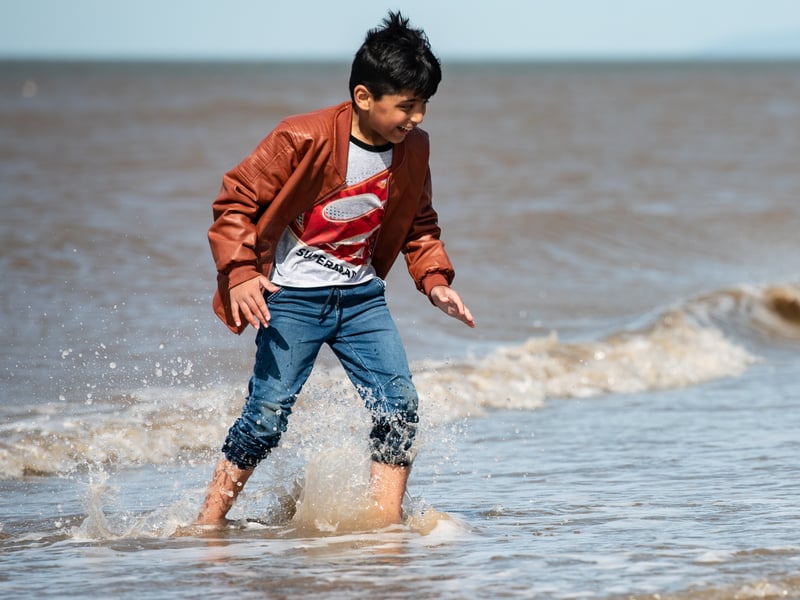 A child paddles in the sea. Photo: Lucinda Herbert