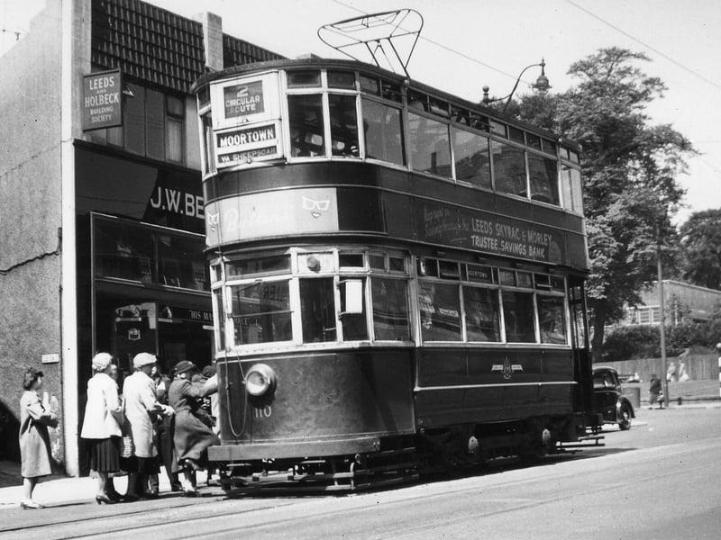 Chamberlain tram no.110, on route 2 to Moortown, stopping to pick up passengers on Harrogate Road in June 1951. To the left of the photo is no.51 Harrogate Road, which is home to J.W. Bennett radio and the Leeds and Holbeck Building Society, by the junction with Club Row.
