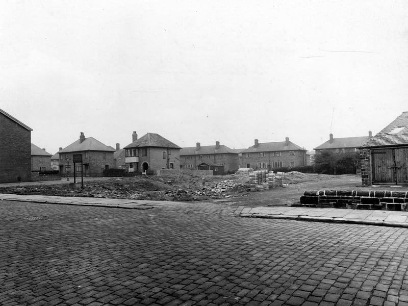 Looking north-east across Seaforth Road at a piece of waste ground between Trafford Grove on the left, and Harehills Garage on the right. Pictured in November 1948.
