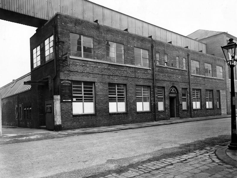 The premises of Kaufman Brothers Ashton Clothing Works, and registered office on Ashton Road in January 1949. At the left-hand corner of the brick building are two signs; one indicating employers entrance, the other advertising vacancies.