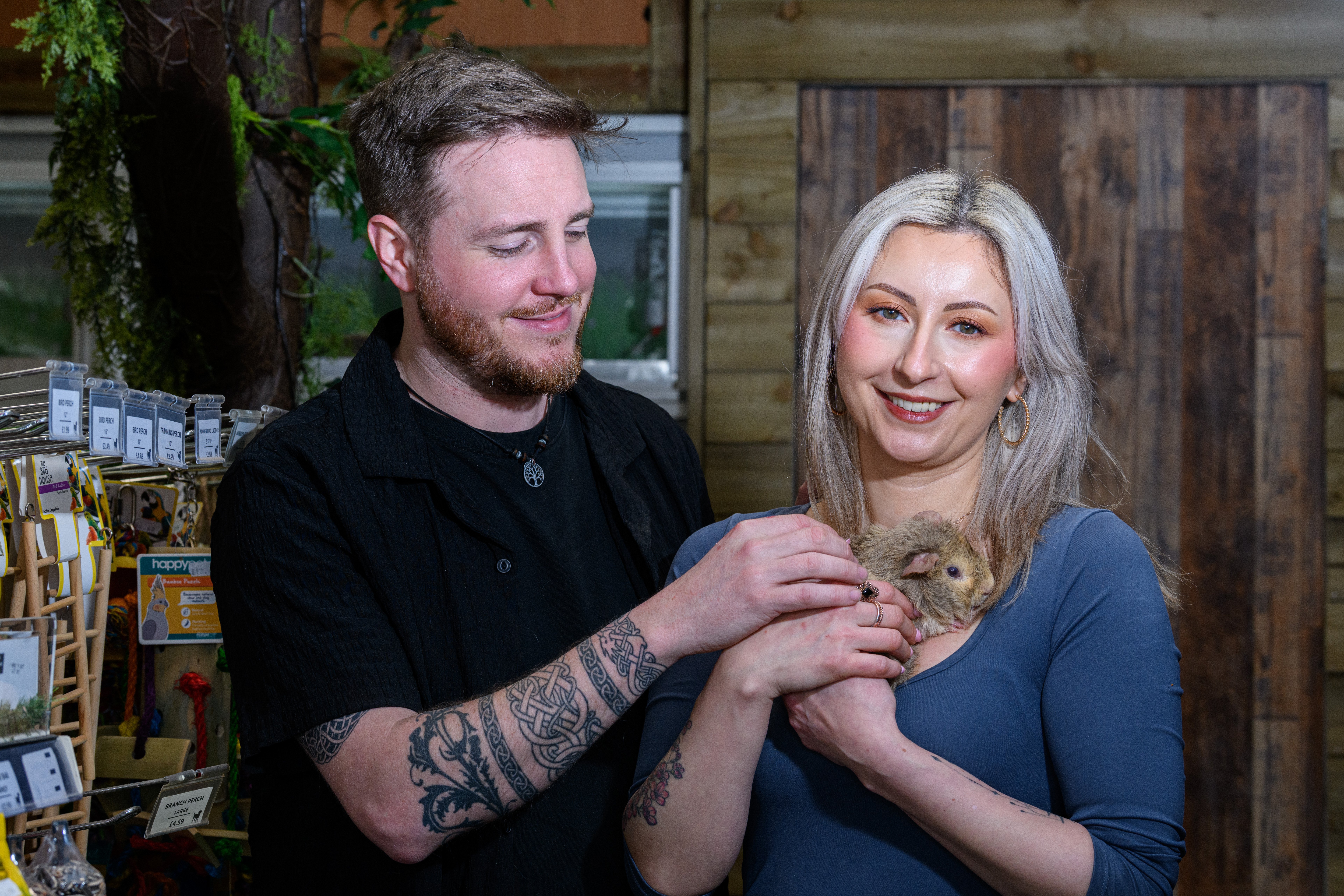 Callum Watson and Maria Enache with a guinea pig at Happy Pets and Aquatics in Preston. 