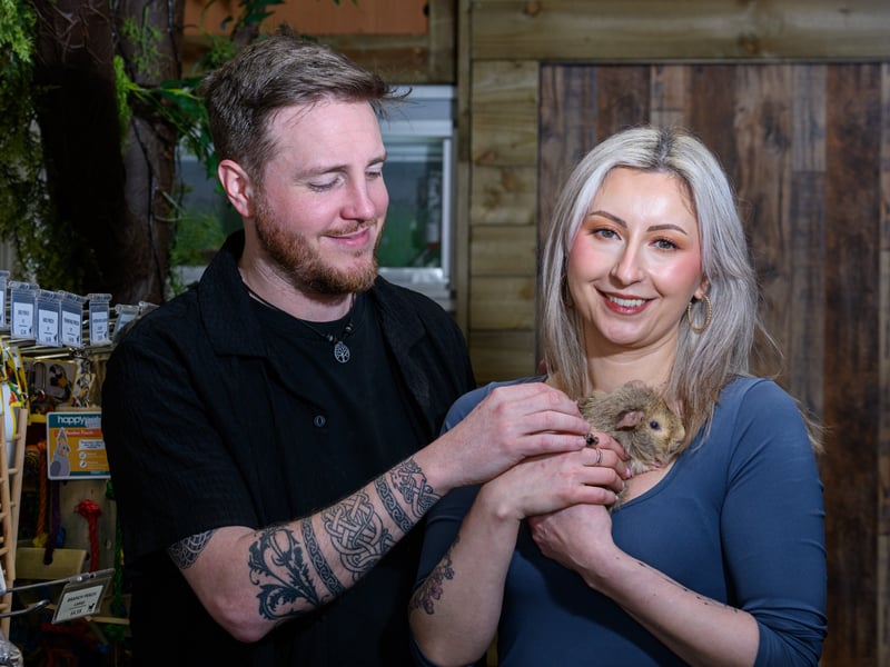 Callum Watson and Maria Enache with a guinea pig at Happy Pets and Aquatics in Preston. 
