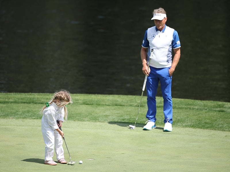 Bernhard Langer of Germany and guest take part in the Par Three Contest.