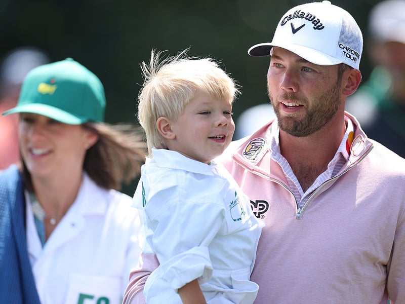 Sam Burns of the United States walks the sixth hole with his wife Caroline Campbell Burns and son Bear.