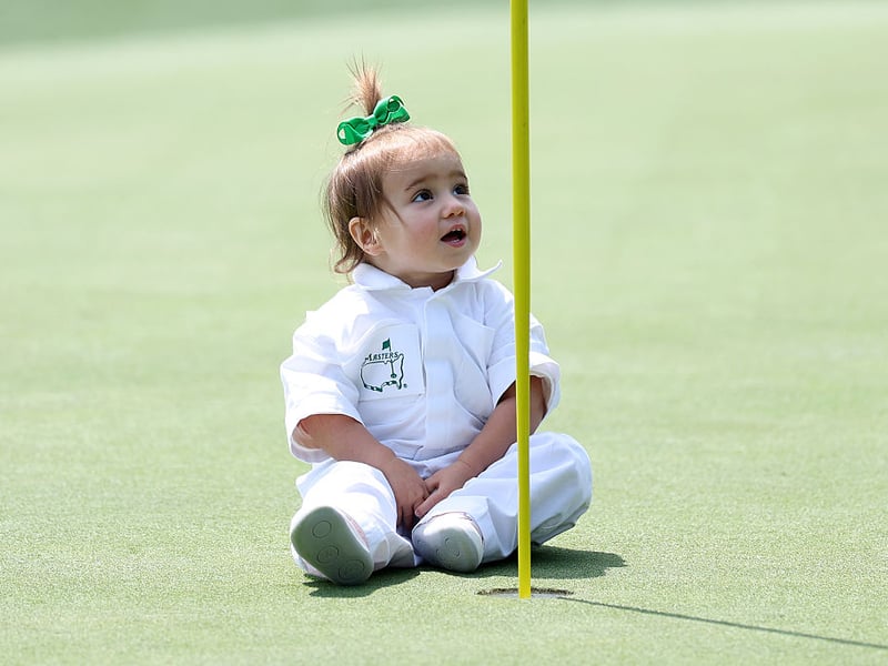 Molly Grace, daughter of Justin Thomas of the United States, sits on the second green.
