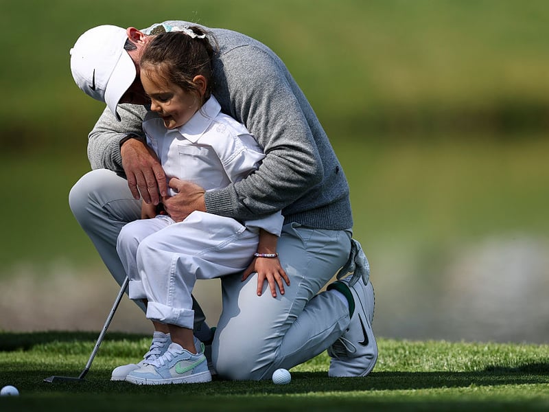 Rory McIlroy of Northern Ireland sits with his daughter Poppy.