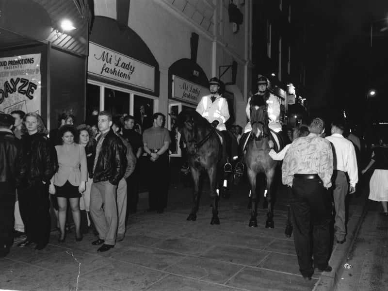 Mounted police pass hordes of club and pub goers as they patrol Westgate, Wakefield, in April 1991