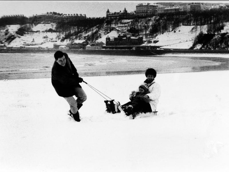 David and Joy Wilcox and three-and-a-half-year-old Elizabeth with their dog, Mitzy, enjoy the snow at Scarborough in February 1991