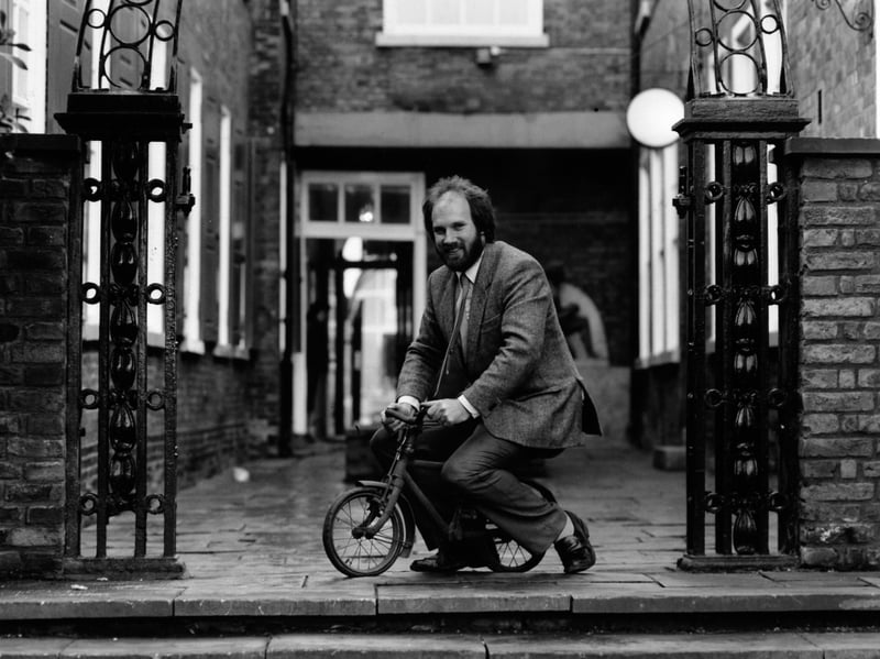 The keeper of transport for Hull Museums, Stephen Goodhand, takes a ride on the smallest bicycle, only 2ft long and 18in high, in November 1991
