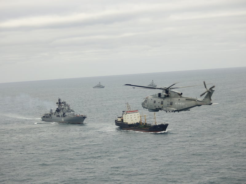 A Merlin from 814 Naval Air Squadron takes part in monitoring operations with HMS Somerset and St Albans