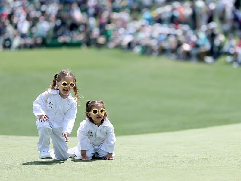 Emerson and Violet, daughters of J.J. Spaun, watch play on the second green.