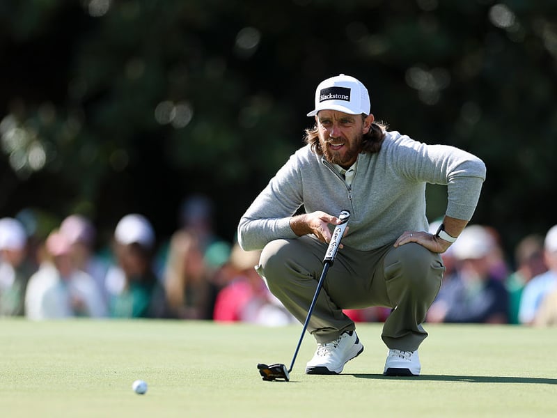 Tommy Fleetwood of England lines up a putt on the first green.