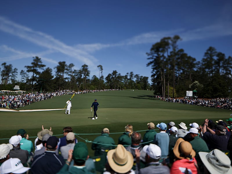 Crowds watch Rory McIlroy on the second green.