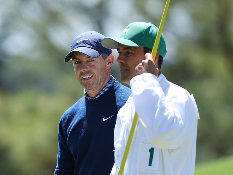 Rory McIlroy of Northern Ireland his caddie Harry Diamond looks on while playing the eighth hole.