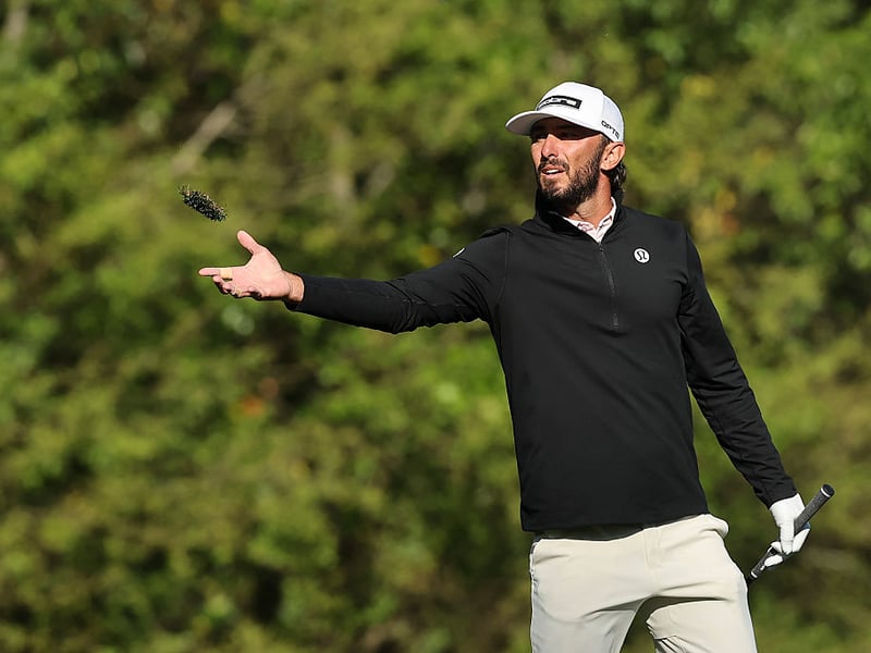 Max Homa of the United States tosses grass from a divot on the fifth hole.