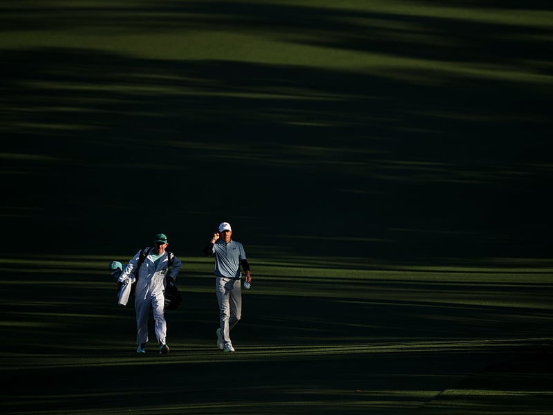 Carlos Ortiz of Mexico walks the second fairway with his caddie Michael Kerr.