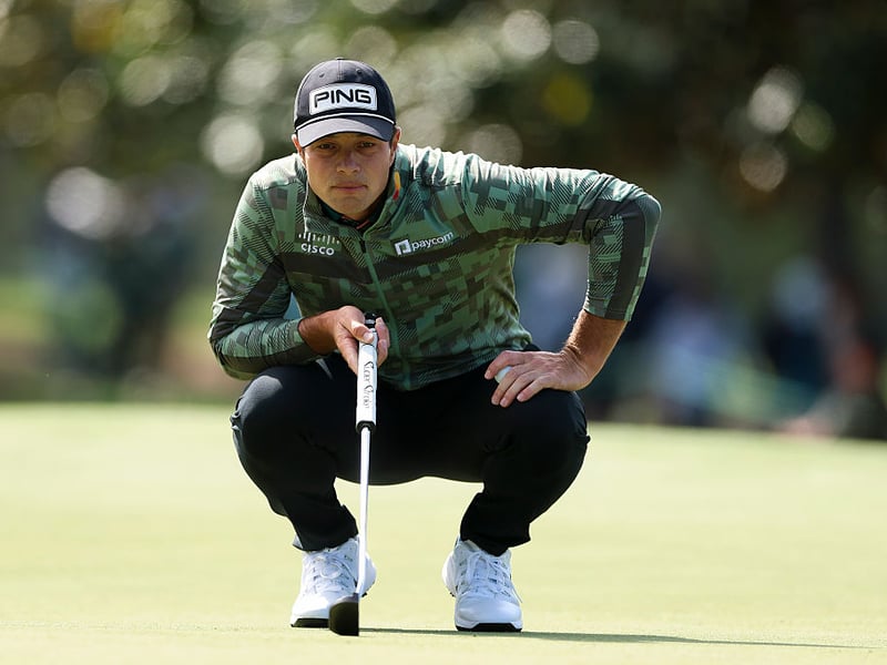 Viktor Hovland of Norway lines up a putt on the first green.