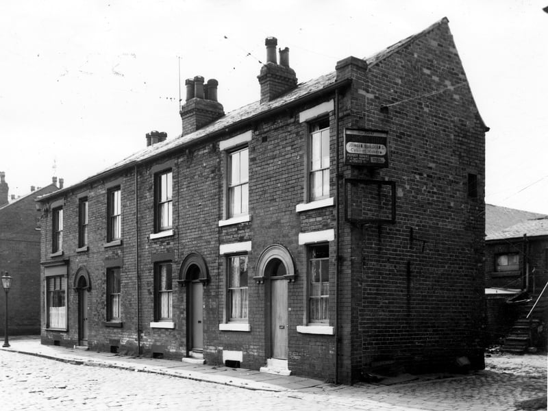Terraced properties in Kirkland Street, from left to right, numbers 35 to 39. Far right is the entrance to the yard and premises of Arthur Day, joiners, builders and cabinet makers. On the left edge of photo from June 1964, a glimpse of Cross Heald Street is visible. 
