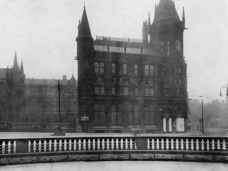 A corner of City Square showing the Park Row face of the Royal Exchange Chambers housing the Automobile Association and W H Bayswater Ltd, Colliers Proprietors among other businesses. In the background can be seen part of the Marsh, Jones and Crabb Ltd building advertised as furnishers and decorators. Pictured in December 1922.