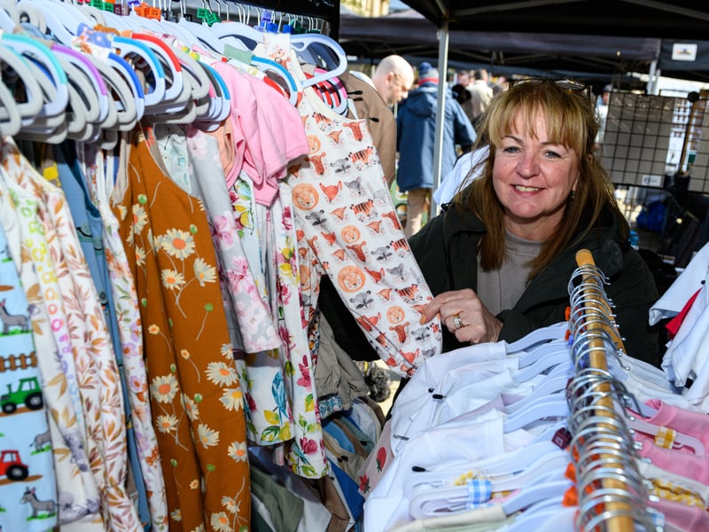 A trader poses with her fabulously patterned clothes