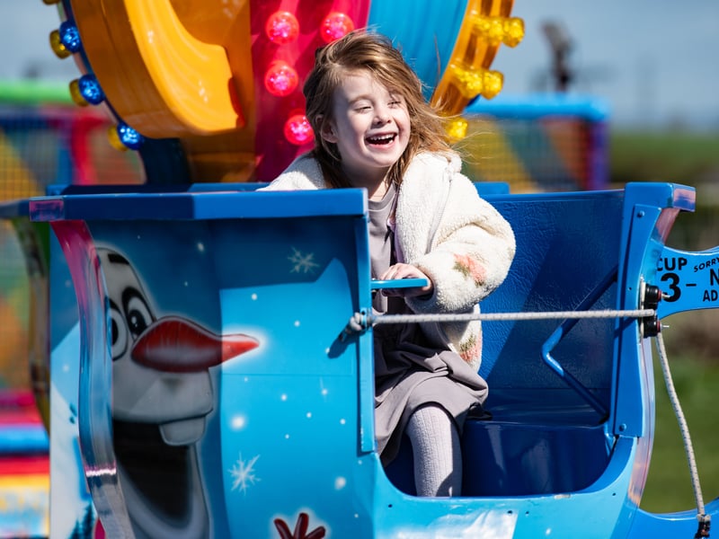 The community event featured a mini funfair with rides for younger children to enjoy.