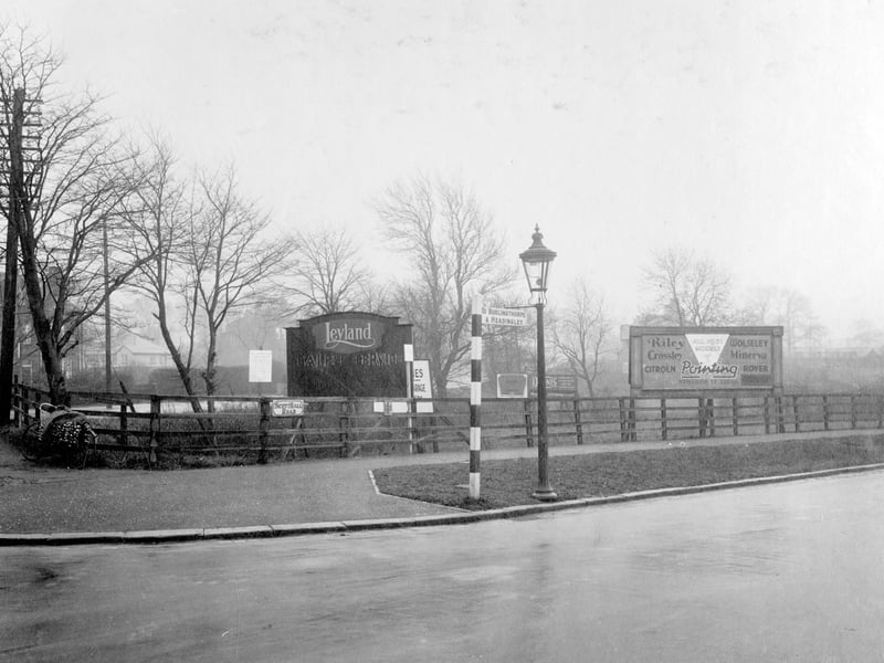 The junction of Harrogate Road and Scott Hall Road. A bicycle is propped up against a fence with a sign for "Scott Hall Road". Pictured in November 1930.