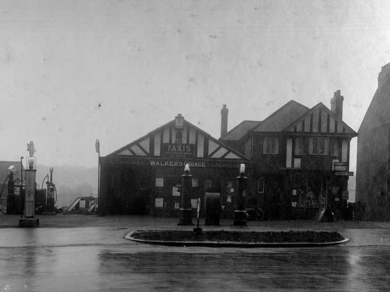 a petrol pump to the left, then the premises of Walkers Garage at number 498 Harrogate Road. Next door is the premises of E. Short post office. Pictured in November 1930.