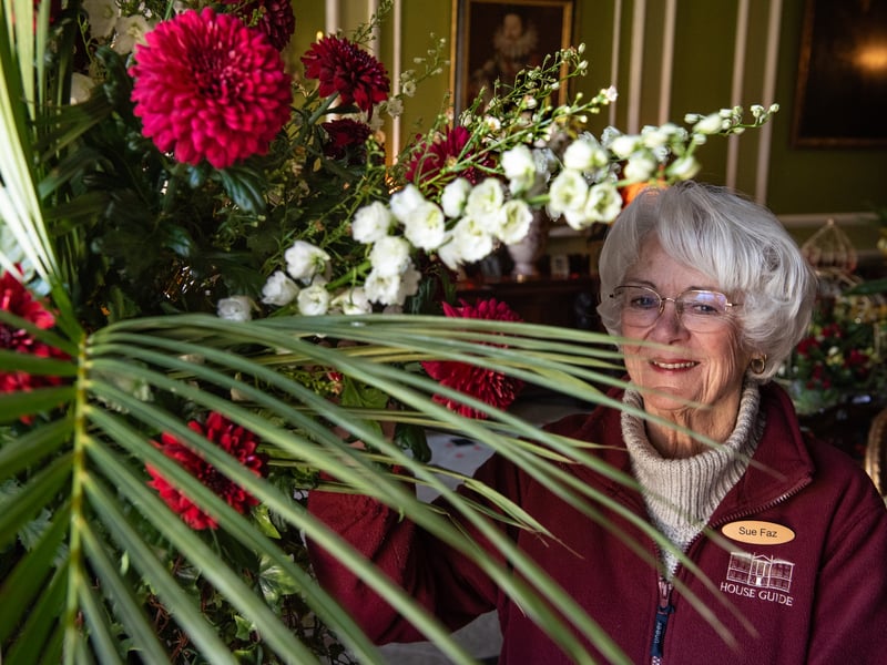 House guide volunteer Sue Faz with some of the gigantic floral bouquets at Lytham Hall.
