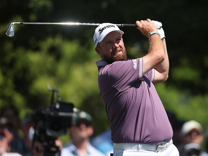 Shane Lowry of Ireland plays his shot from the fourth tee.