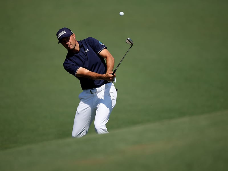 Jordan Spieth chips on to the green at the second hole.
