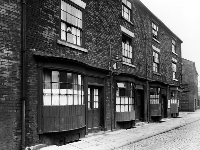 Water Lane, known as Crofts buildings. Three storey brick buildings with bowed wooden windows on ground floor. Pictured in August 1950.