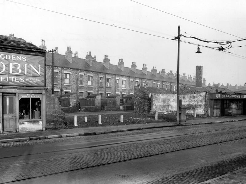 Elland Road in December 1952. This photo looks north through the gap between number 42, Staychrome electro plating Co, and number 52, a tobacconist on Elland Road towards Elland Terrace.