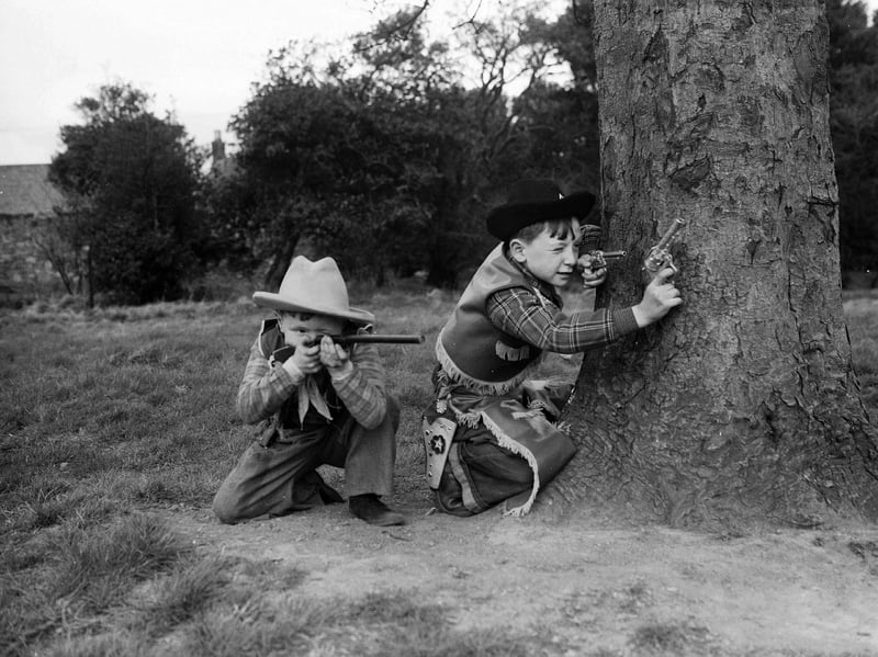 Young cowboys Douglas Currie and Jimmy Graham playing with their toy guns at The Inch, Edinburgh, in April 1954