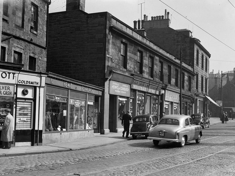 The corner of Chambers Street and Lindsay Place, Edinburgh, in April 1956, with shops including Hewat of Edinburgh, James Lawrie tobacconist, Masons Radio and Television, Territorial Bar, and the Malt and Shovel Bar. The buildings have since been demolished, with the Museum of Scotland now standing on the site.