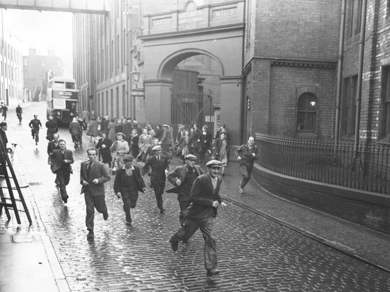 Staff running out of the North British Rubber Company's works at Castle Mills, Edinburgh, at the end of their shift in 1951. It was the city's largest factory at the time, employing 3,664 people, but it closed in 1973.