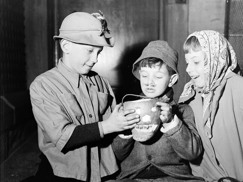 Young Edinburgh guisers warm their hands over their turnip lanterns at Halloween in 1956