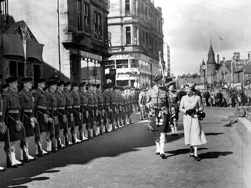 Queen Elizabeth II inspects the guard of honour of the 7th Battalion Argyll and Sutherland Highlanders during her visit to Falkirk in 1955