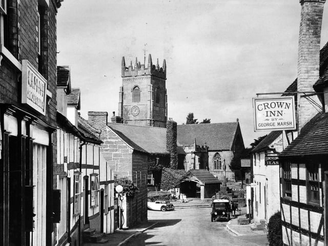 Claverley village, likely 1930s. The scene shows the Crown Inn (kept by George Marsh) on the right, with its distinctive leaning chimney stack, and Claverley Church in the distance. The postcard was later franked in Stourbridge on August 28, 1942, carrying a personal message from Dennis to his father, joking about washing up and looking forward to being home on Sunday evening. It was addressed to T. Mackie Esq, 18 Oldfields Road, Sutton, Surrey, and is pictured courtesy of Bridgnorth postcard collector Ray Farlow.