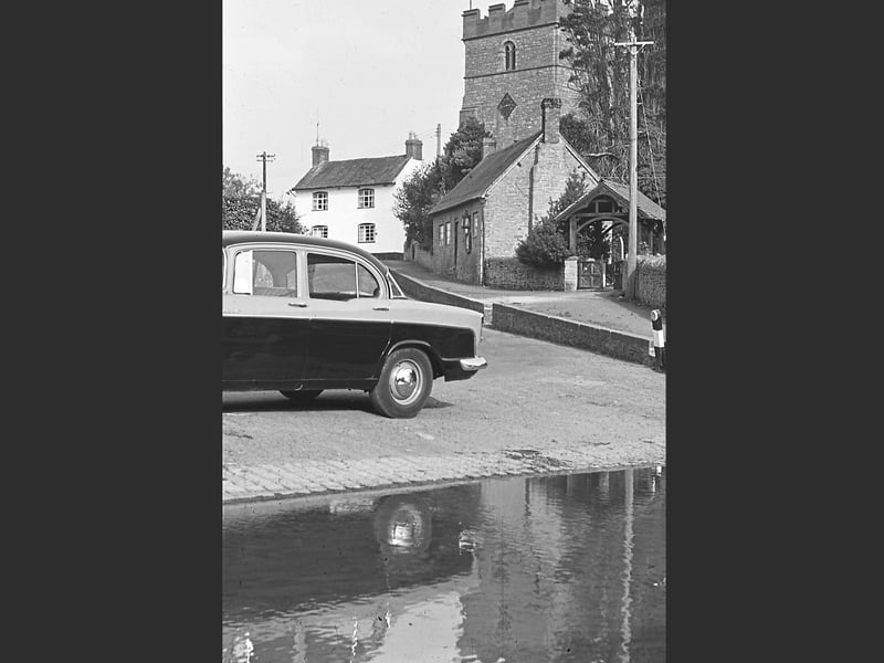 Diddlebury village, showing the ford at Diddlebury, and also Diddlebury church. This picture was taken at an outing of Bridgnorth and District Camera Club in 1962. It was shared by Ralph Walker of Bridgnorth.