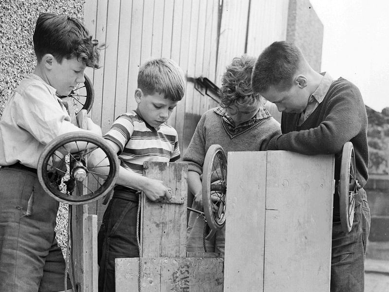 Young mechanics make adjustments to their guiders, or go-karts, in Edinburgh in August 1957