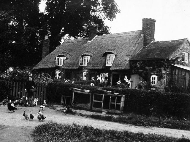 Village Road in Norton, near Shifnal, captured in a postcard franked on 11 September 1912, featuring Monkins Cottages and photographed by Bartlam of Madeley; the card carries a birthday message sent to Sheffield and was later annotated with family memories.
