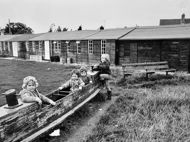 Children play outside Bicton village hall in October 1974.
