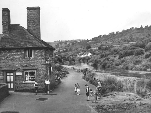 This picture taken in August 1952: 'Jackfield, the tiny Shropshire village almost cut off from the world since its main road began to slide into the River Severn, is doomed. The inhabitants have started to evacuate their homes before the danger of subsidence becomes worse. The post office (left) is to be evacuated before winter comes.'
Jackfield post office was run by Mrs Elsie Bradburn.