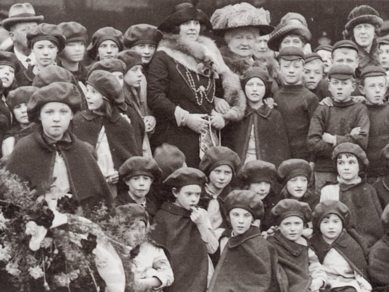 The 10,000th child to be sent for a holiday at Silverdale was presented with a bouquet of flowers at Central Station in 1922. Helen Currer Briggs stands in the midst of the children with the Lady Mayoress, Mrs Fountain.