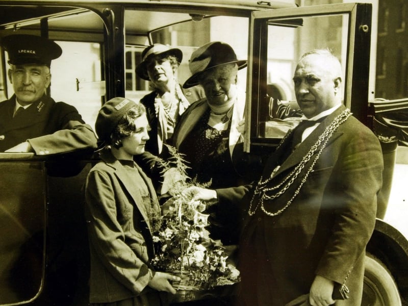 The Lord Mayor of Leeds, Alderman Hemingway, greets Carrie Palmer on her return from Silverdale in June 1935. She was the 20,000th child to visit the holiday camp.