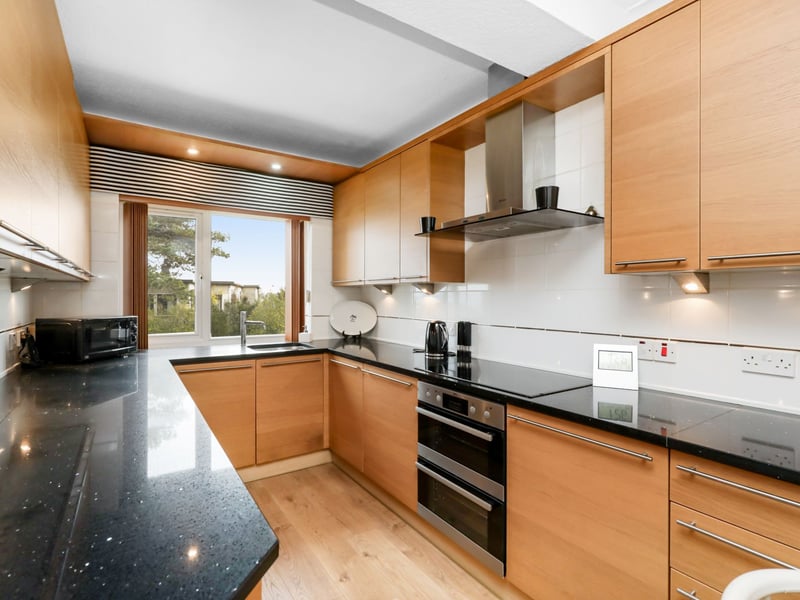 The contemporary breakfasting kitchen with attractive units and a useful W/C compartment with ample sized storage.