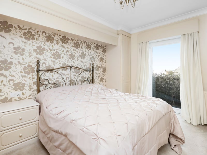 Following up a carpeted staircase the upper level this master bedroom with balcony.