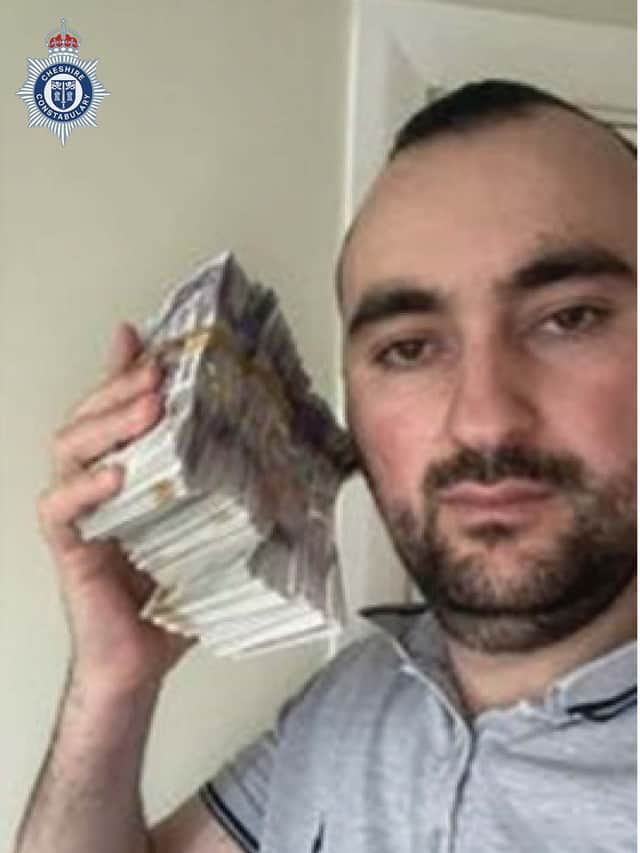Sidorjan Lleshi posing with cash