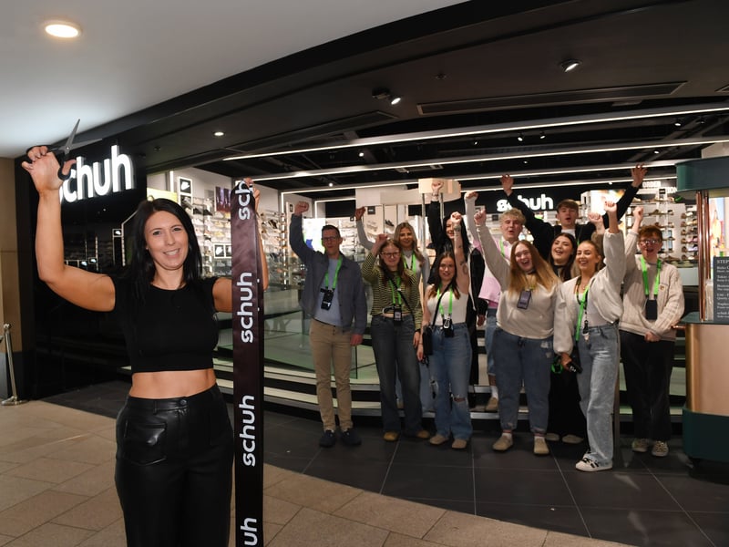 Store manager Liz Peacock cuts the ribbon to officially open the store.